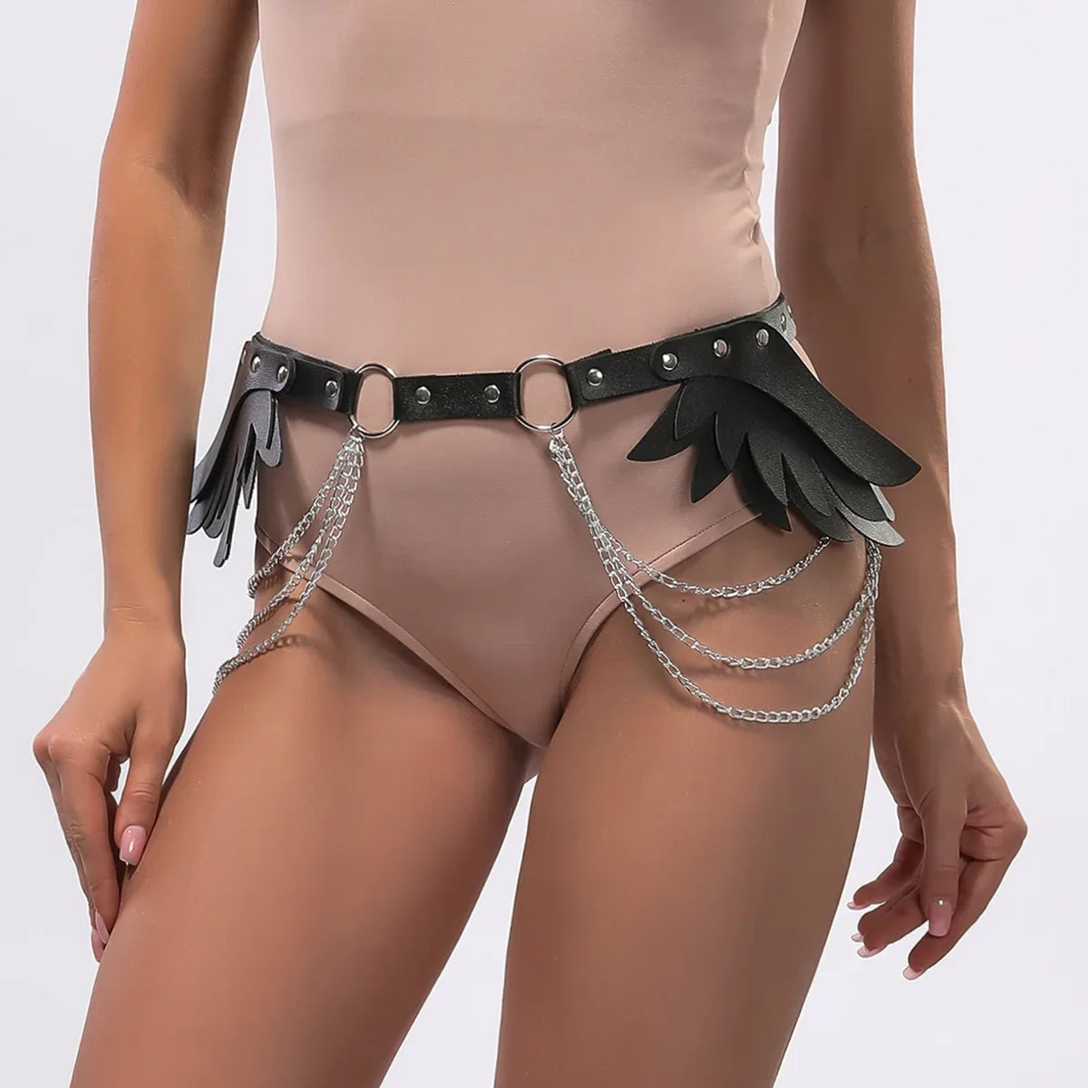 close-up of leather angel wings and chain detailing on waist belt for fashion-forward edgy outfits