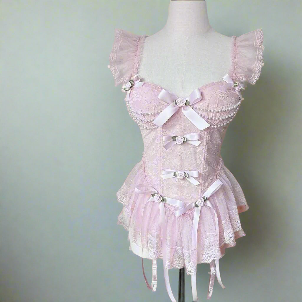 Baby pink lace corset with ruffle trim, pearl details, and bows for kawaii DDLG lingerie aesthetic