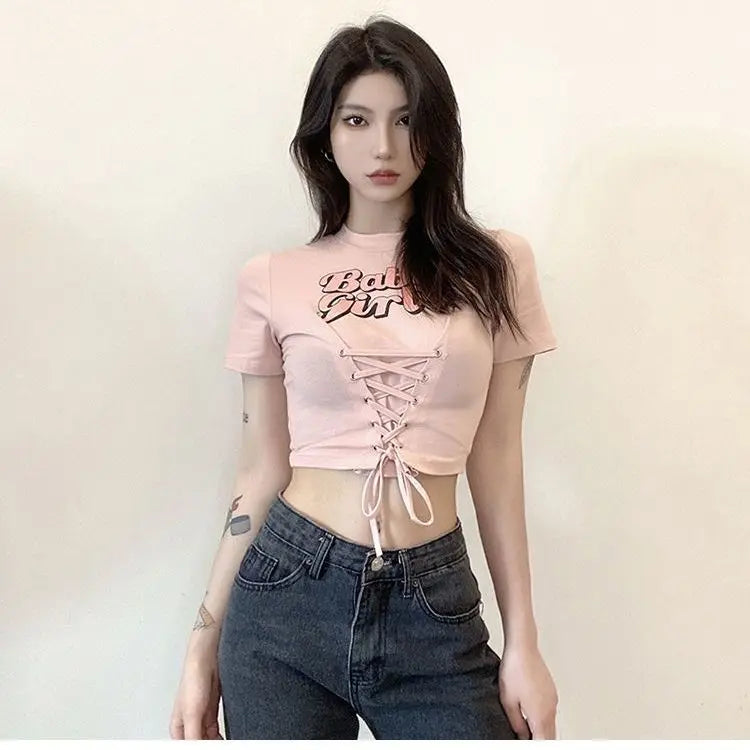 Babygirl Glow pink crop top with lace-up front and babygirl aesthetic details