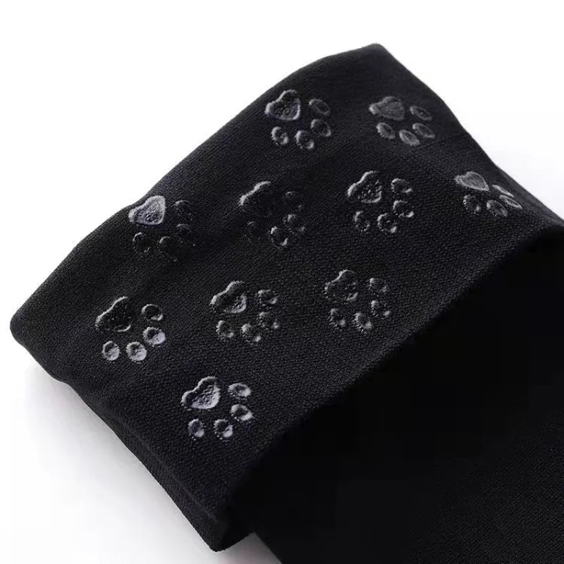 Black 3D pawprint pop stockings with pastel vibes, soft stretchy fit for kawaii ABDL DDLG cutecore outfits