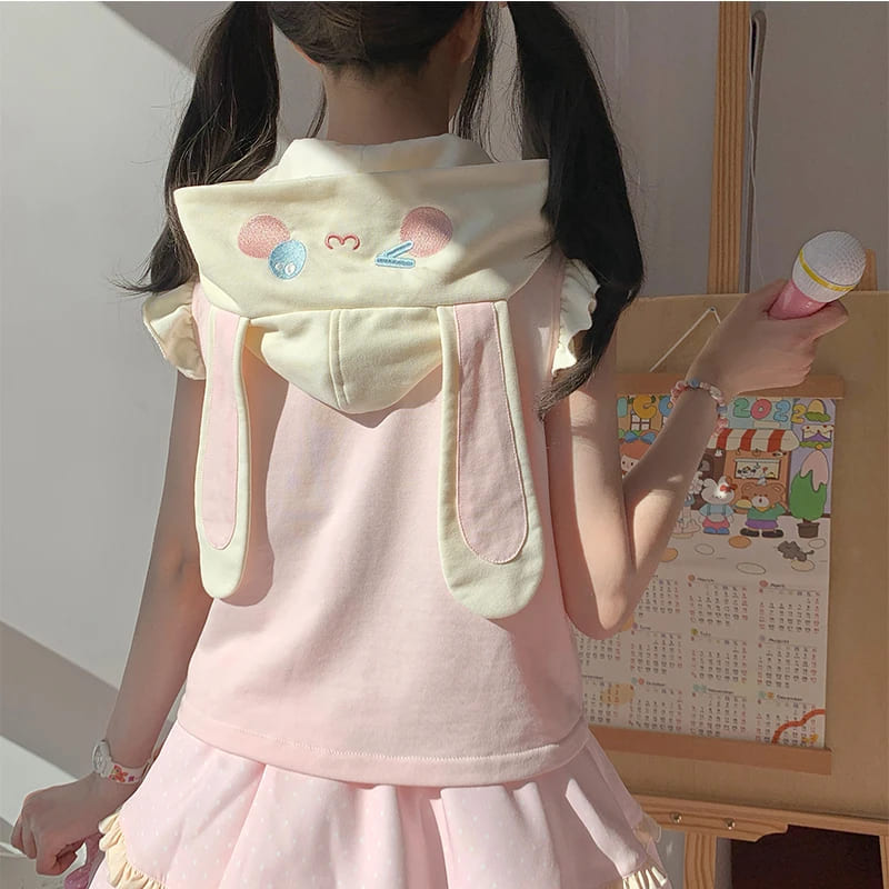 Pastel cream, pink, and yellow vest with delicate ruffle trims for cute and cozy look