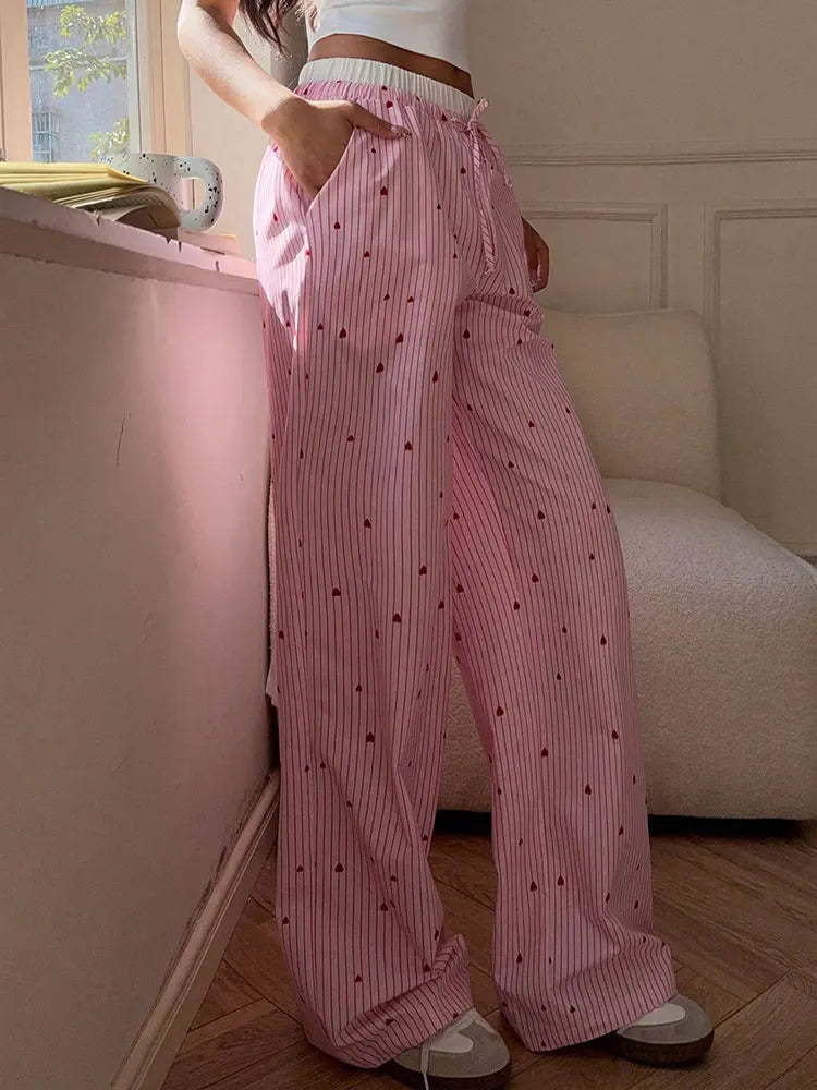 Candycore pastel pink striped lace pants with romantic heart lace-up, ideal for soft baddie and dollcore looks