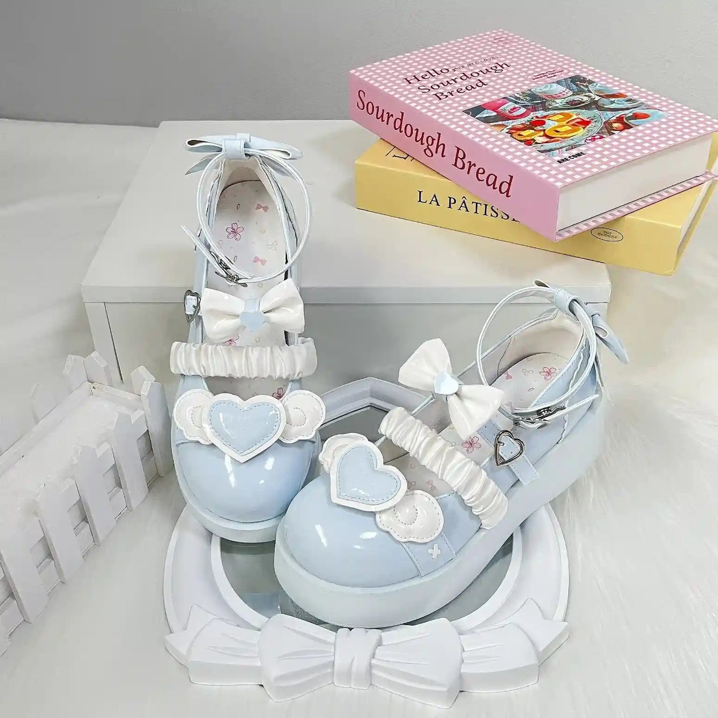 Baby blue Cherub Heart Cutie Platforms with cute 3D bows and angelic heart details, ideal for lolita and ABDL styles.