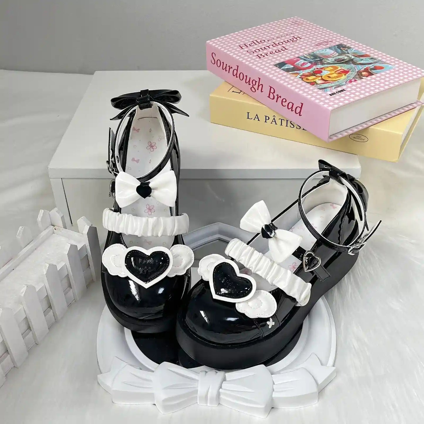 Black Cherub Heart Cutie Platforms with delicate angel wings, 3D bows, and raised heart centerpiece, dreamy and kawaii.
