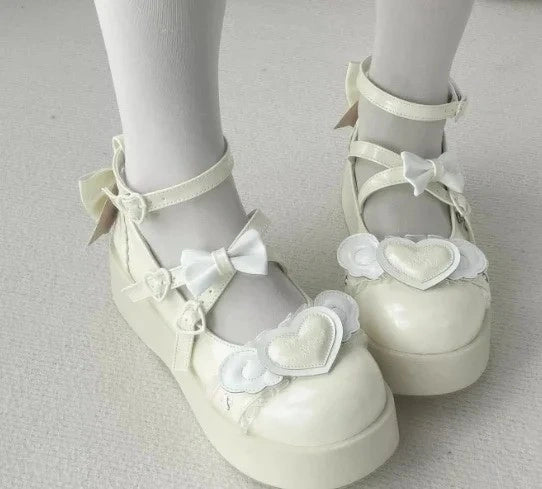 Pastel yellow Cherub Heart Cutie Platforms with fluttery angel wings and heart centerpiece, perfect for kawaii DDLG fashion.