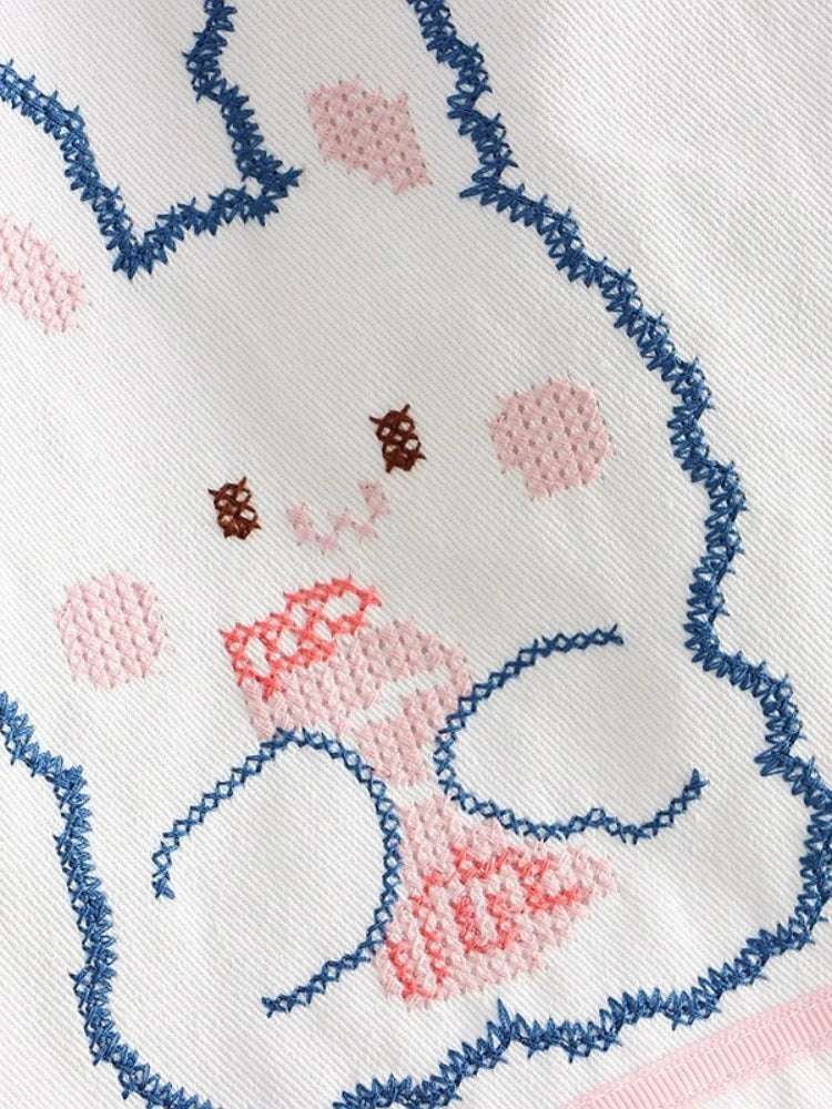 Detailed close-up of white bunny patch on pastel bunny drip sweatpants, ideal for kawaii and ABDL fashion