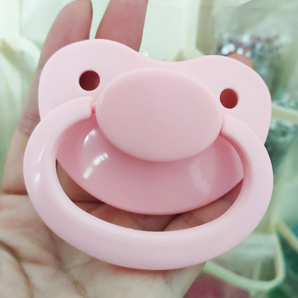 Colorful dragon resting on rainbow pacifier for ABDL, DDLG, and babycore comfort