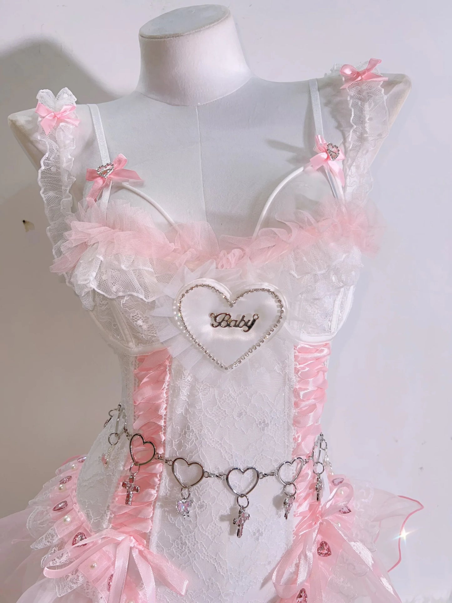 Corset set with pink lace and baby script text, combining cheeky charm and soft glam for babygirl and ABDL expression