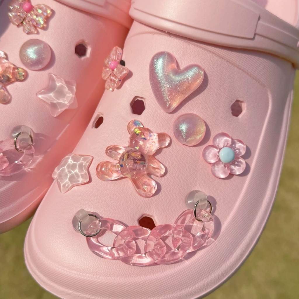 Cute pink sneaker charms with glam accents like bears, hearts, and chains