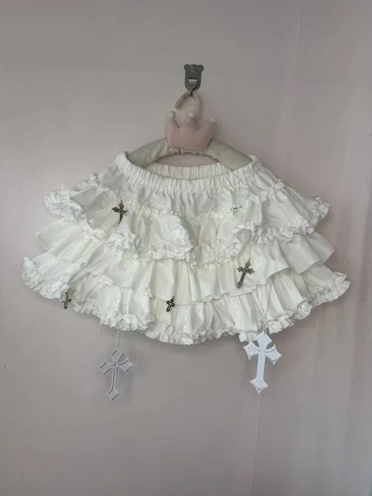 White gothic lolita skirt with standout cross appliqués, frilly layers, and comfy waistband for DDLG ABDL fashion