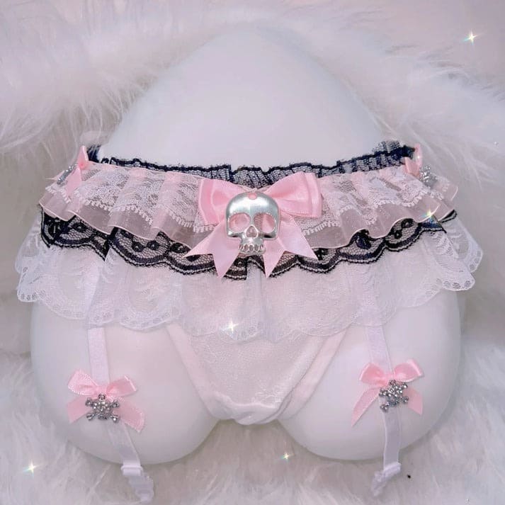 Black lace thong and garter set with skull accents, blending cute Harajuku and alt lingerie styles