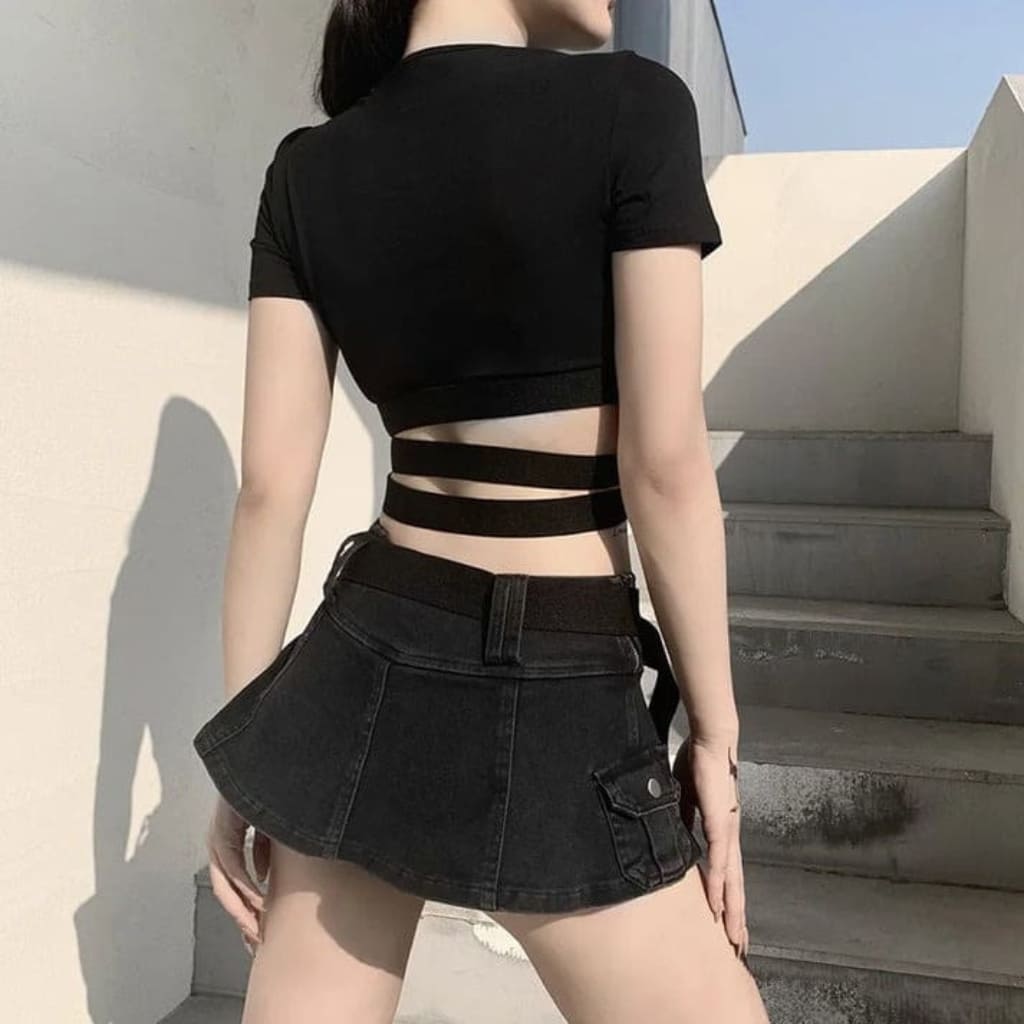Streetwear-inspired Baby Girl crop top styled with pleated skirt for a Y2K and grunge fashion vibe