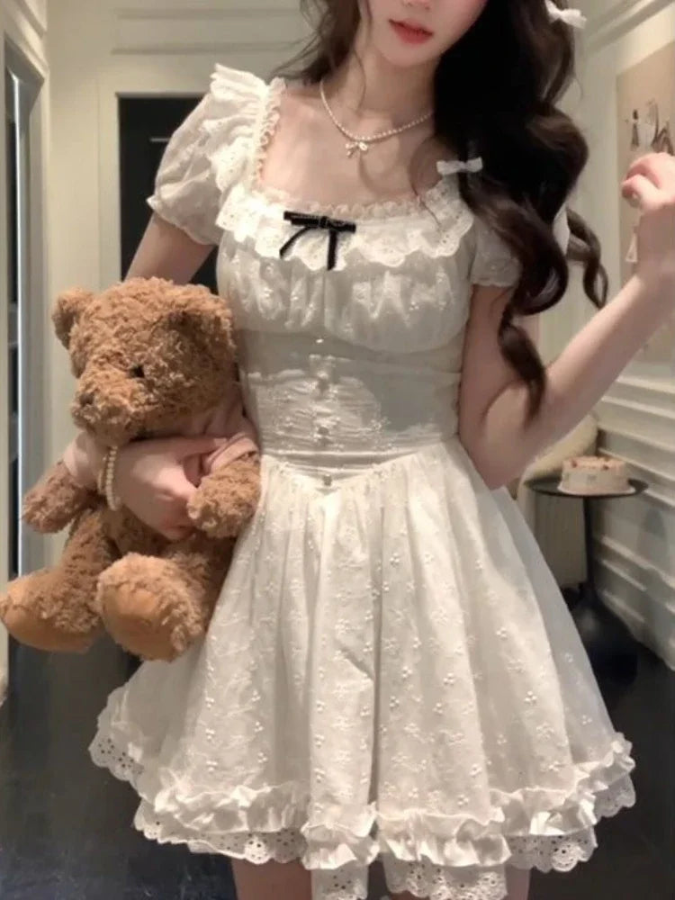 Frosted Lolita Mini Dress in white with frills and black ribbon, kawaii DDLG ABDL cutecore style.
