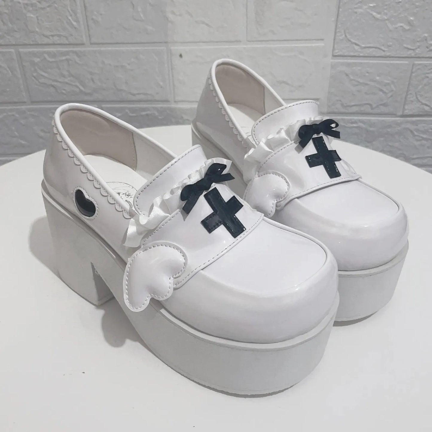 Bold yet sweet Healing Halo Platform Heels with frilly bows, ethereal wings, and heart embellishments