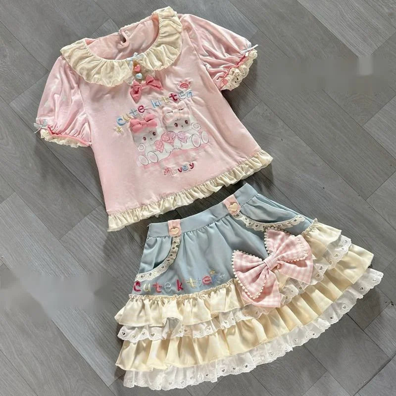 Kawaii fashion set with kitten print, bows, and heart accents in pastel colors