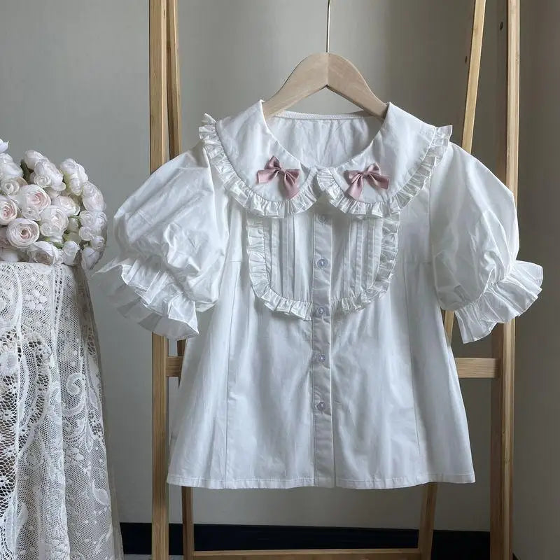 Kawaii lolita blouse with soft cotton fabric, bubble sleeves, and ruffle details for layered looks