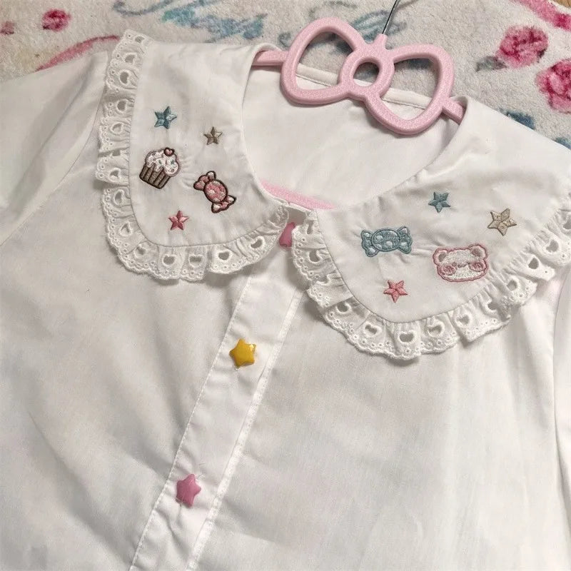 Pastel kawaii babydoll blouse featuring adorable baked goods and treats print
