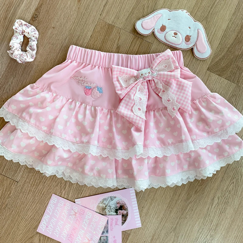 Close-up view of pastel pink mini skirt with center bow from kawaii outfit