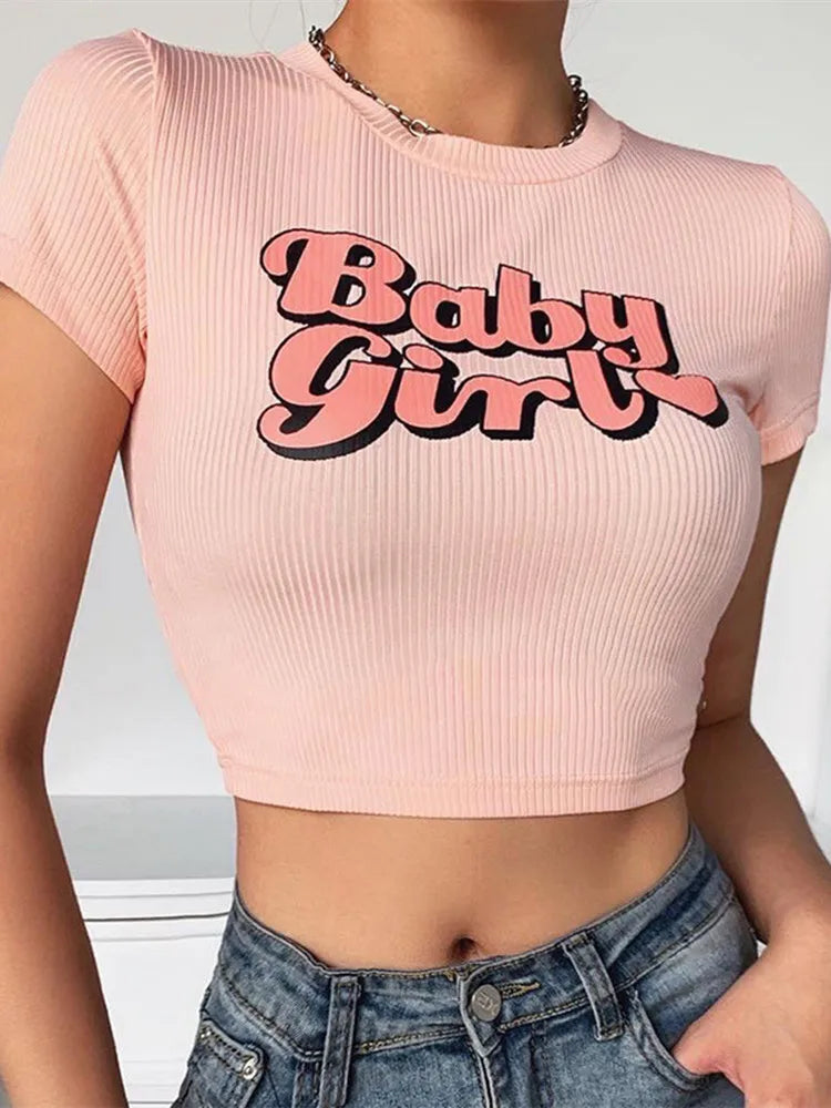 Flat lay of pink babygirl crop top for DDLG and ABDL fashion