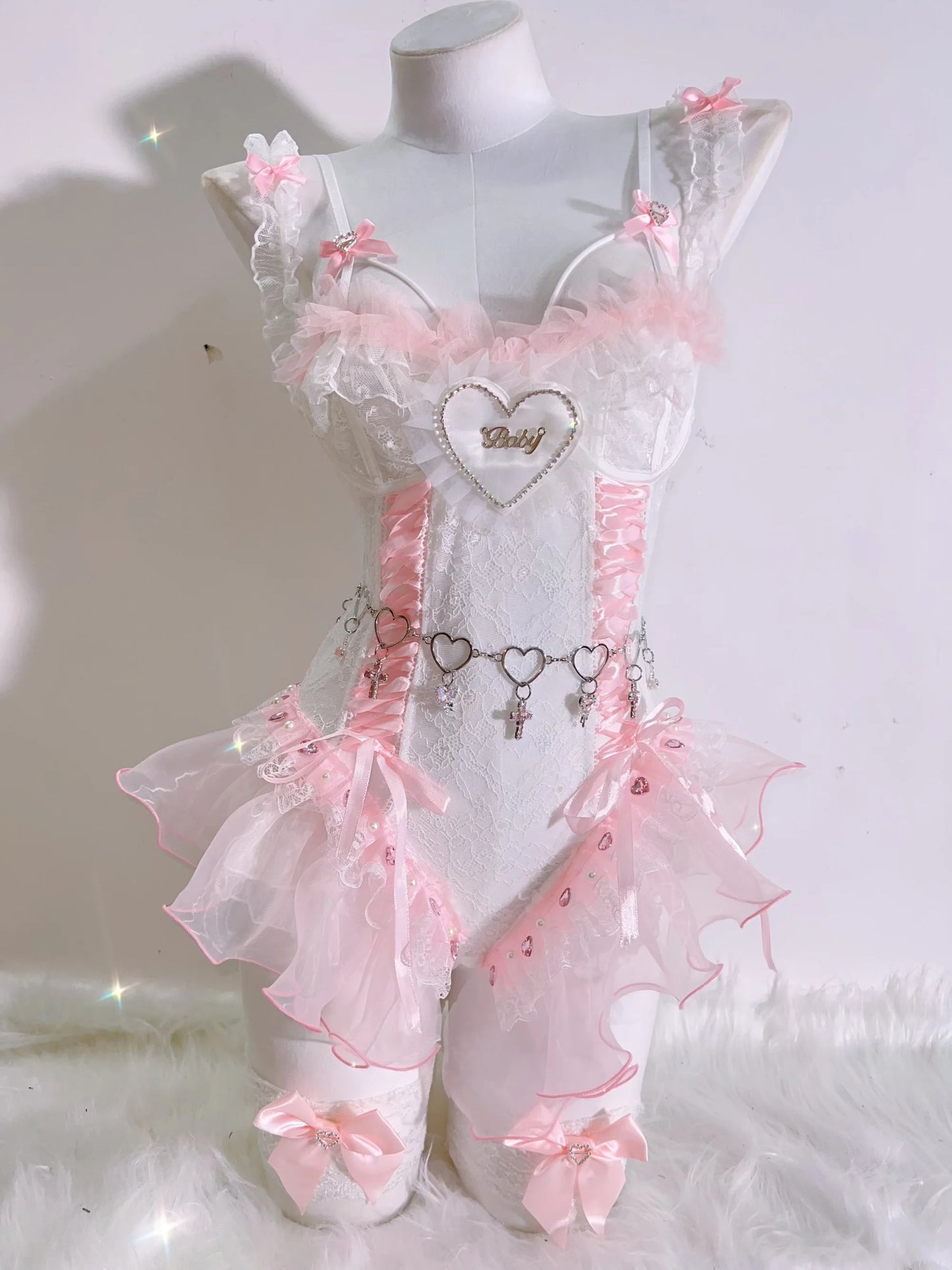 Pink corset top featuring adjustable lacing and “baby” script, delicate lace and satin blend for a luxe babydoll look