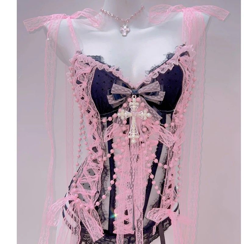 Glam pink lingerie set with lace, cross details, and sheer fabric to enhance curves stylishly.