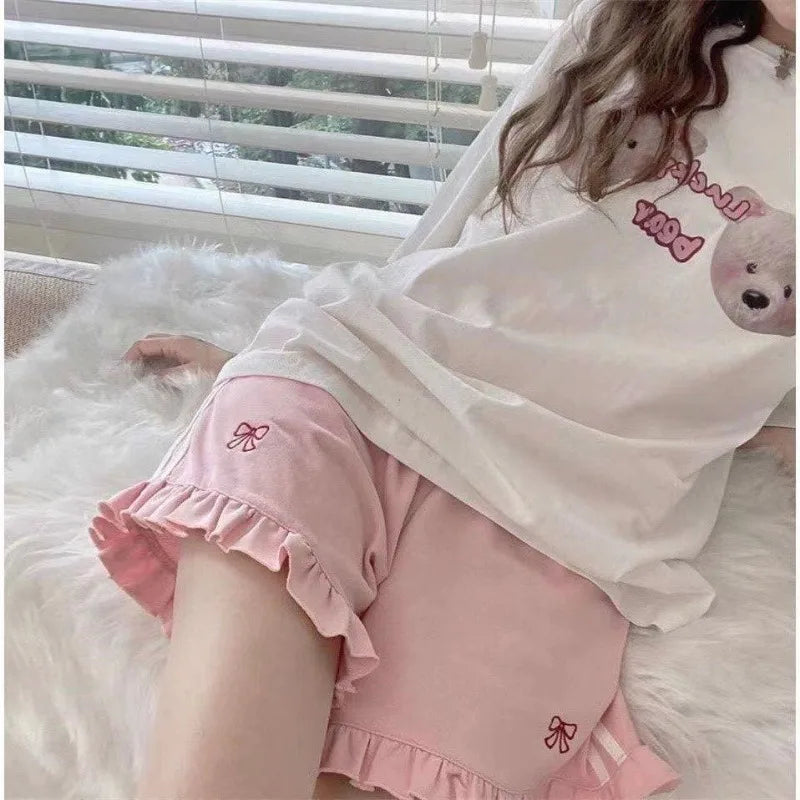 Pink princess track shorts with ribbon accents, mini ruffles, and white side stripes for DDLG ABDL style
