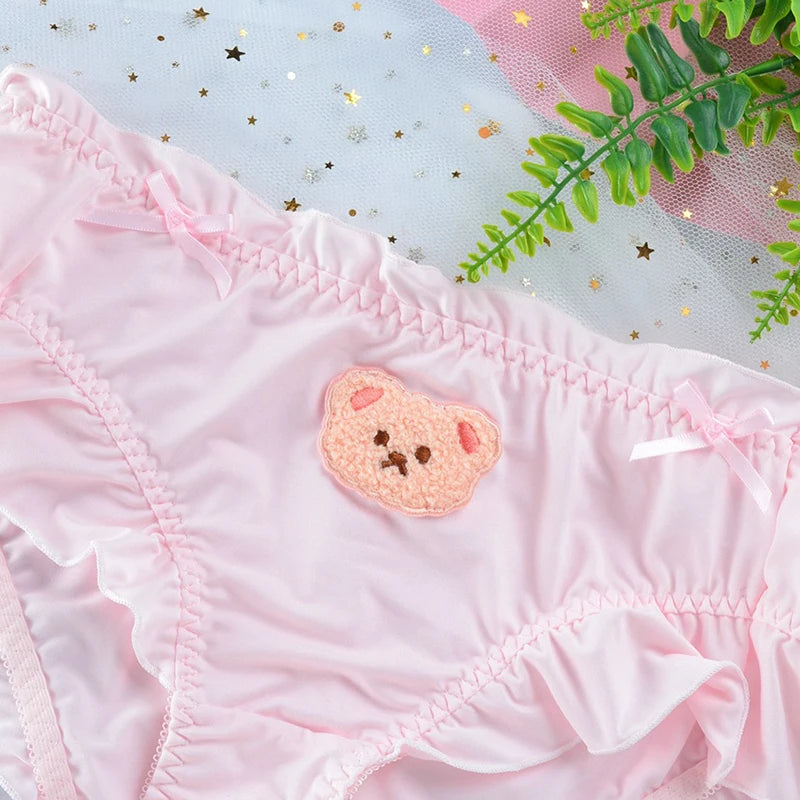 Close-up of pink teddy ruffle panties featuring frilly edges and stretchy waistband for comfortable fit