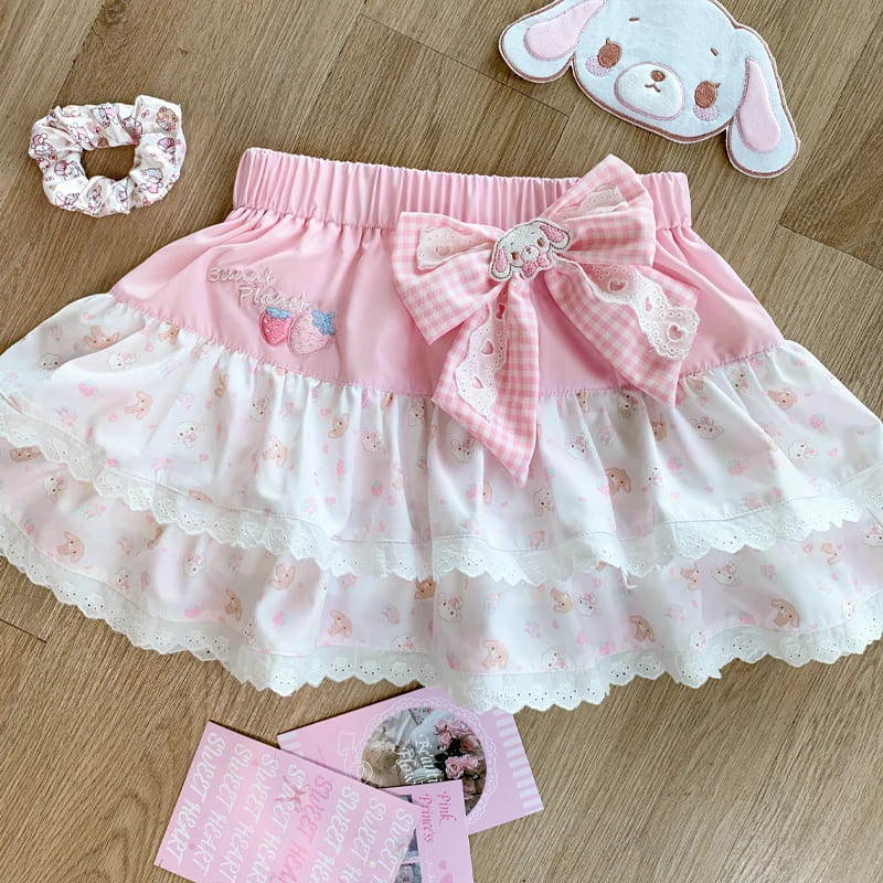 Close-up of pastel pink and white mini skirt with pink bow detail from kawaii set