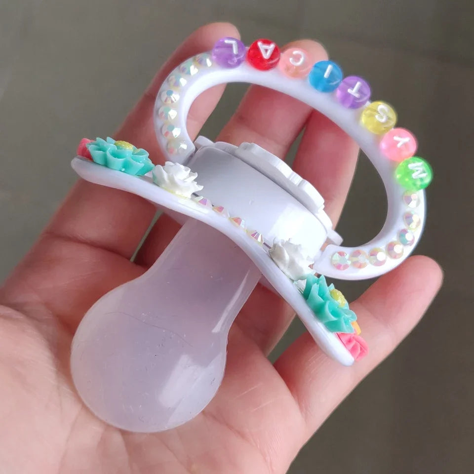 Whimsical dragon pacifier featuring floral details, ideal for safe and comfy regression play