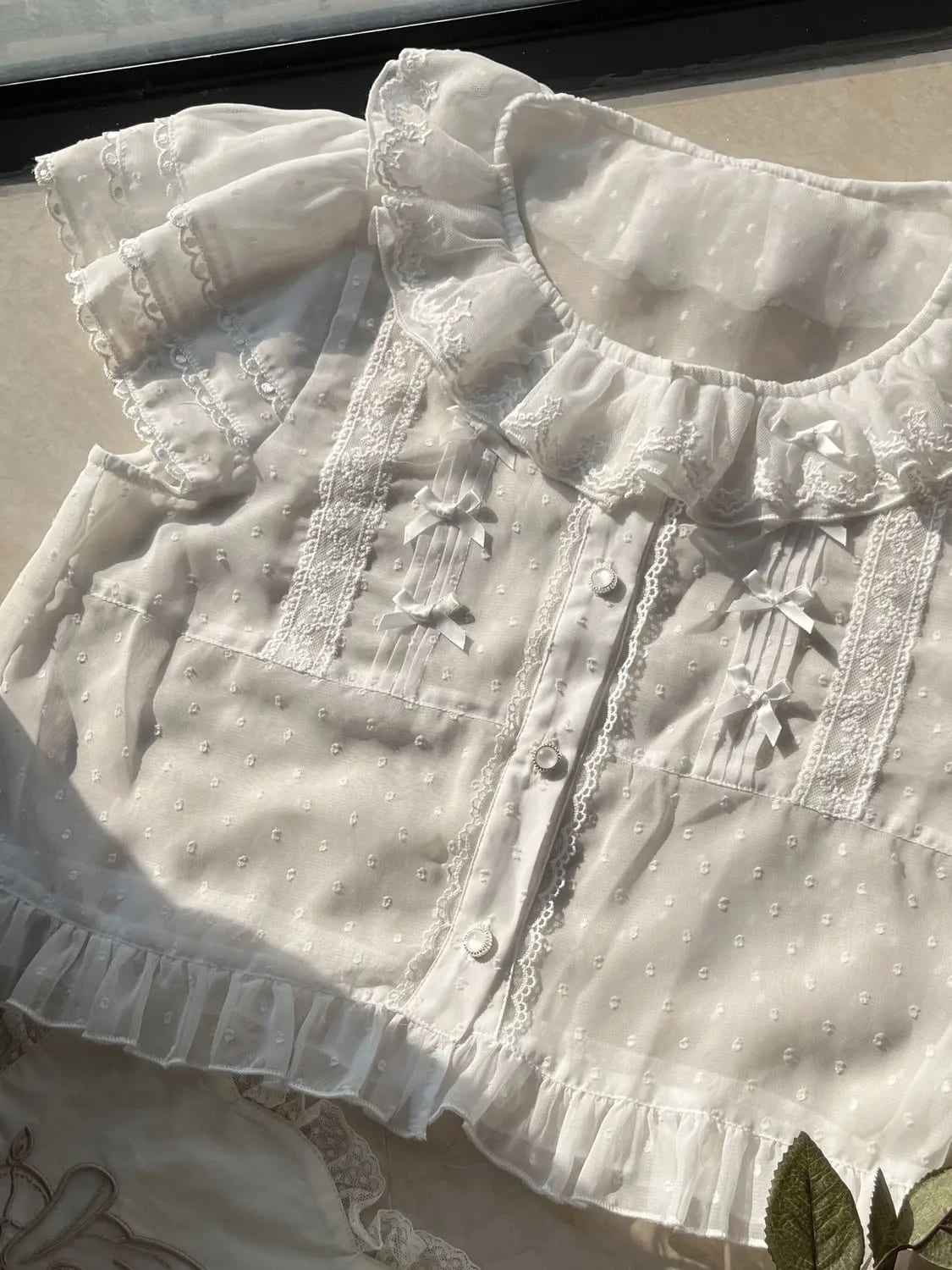 Side view of white ruffled fairycore top in lolita fashion with puff sleeves
