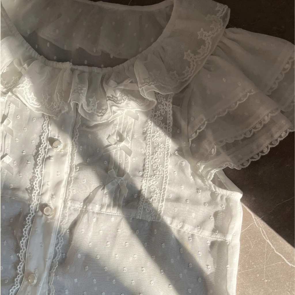 White lolita blouse with soft ruffles and a kawaii fairy tale vibe