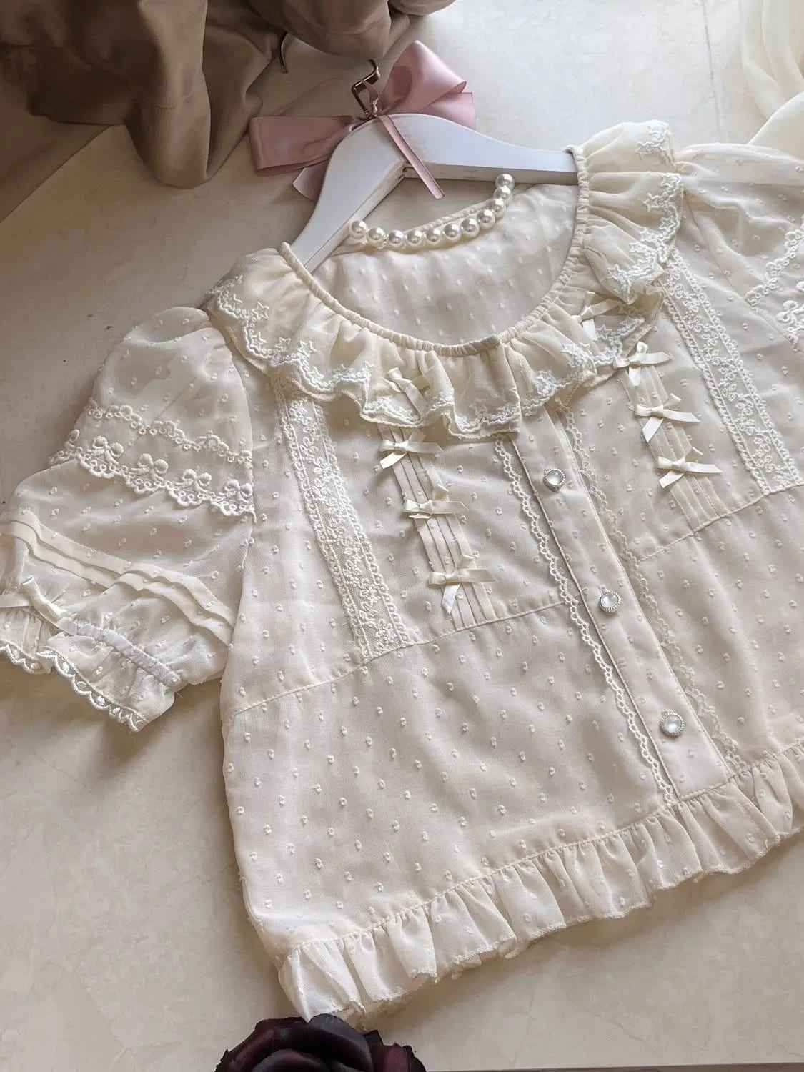 White ruffle lolita blouse in fairycore kawaii style with lightweight fabric and puff sleeves