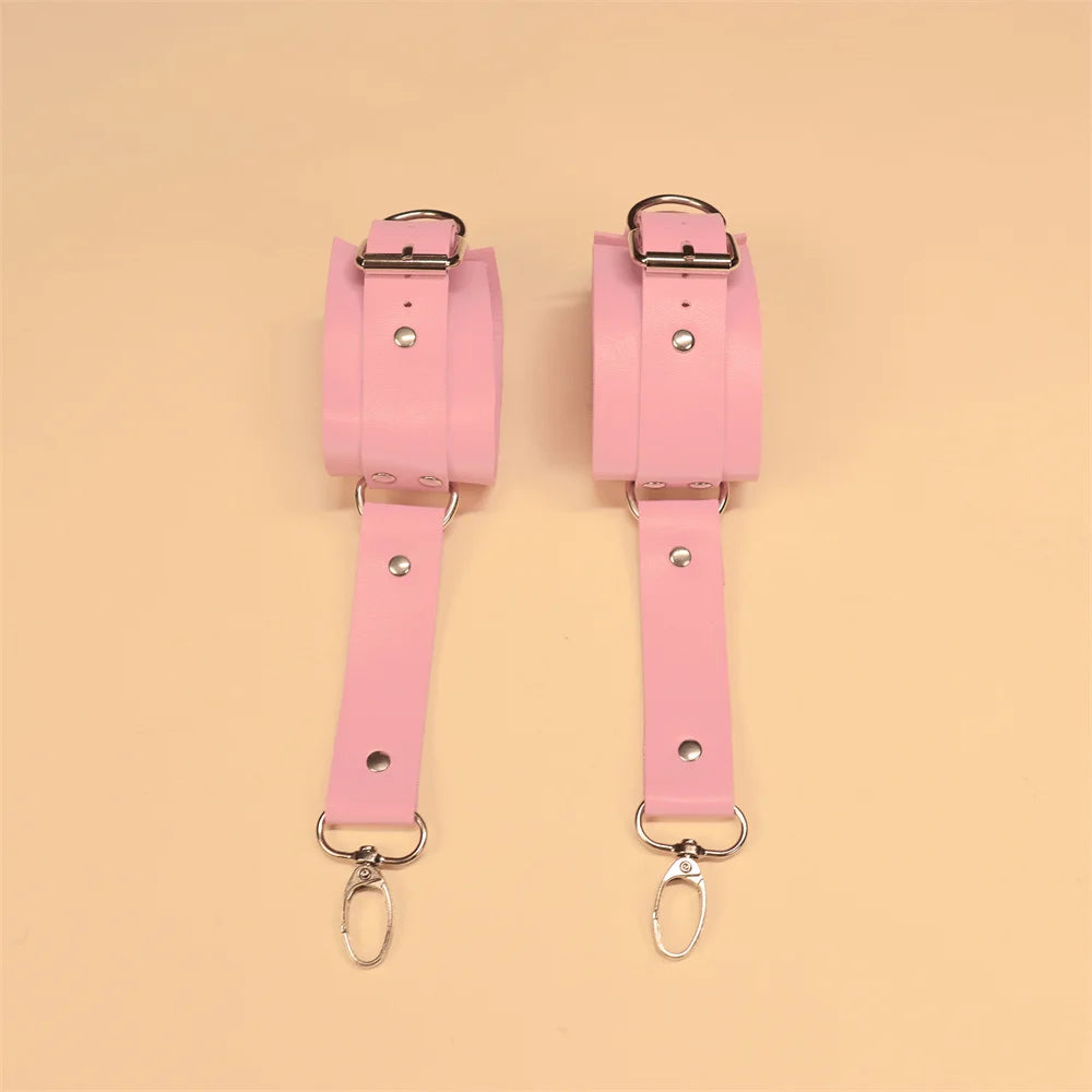 Adjustable pink faux leather wrist-to-thigh harness with delicate handcuffs and belt accents