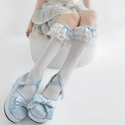 Soft white sheer fabric texture detail on baby blue doll stockings