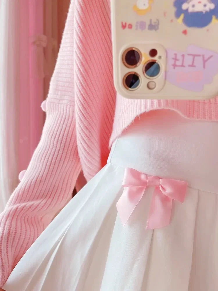 Model showing satin pink bow detail on Baby Doll pleated skort