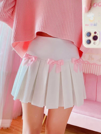 Model wearing Baby Doll Pink Bow pleated skort outdoors, Y2K schoolgirl style