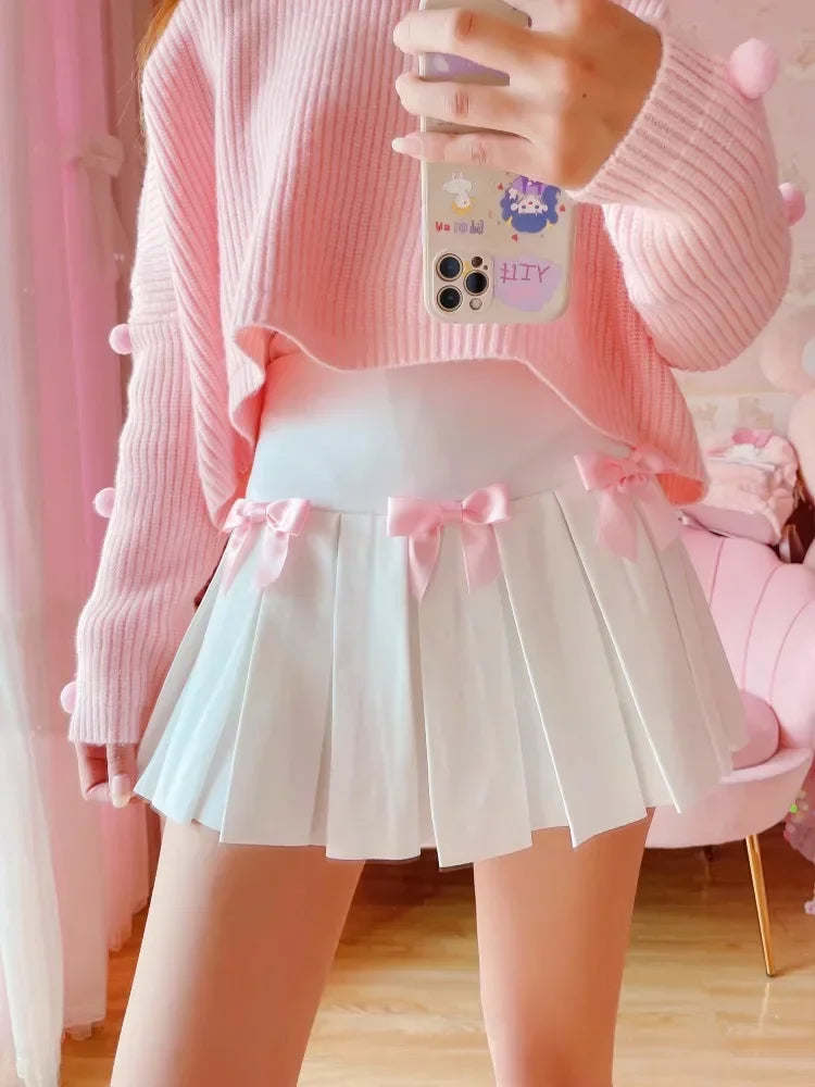 Model posing in Baby Doll Pink Bow pleated skort, coquette preppy style