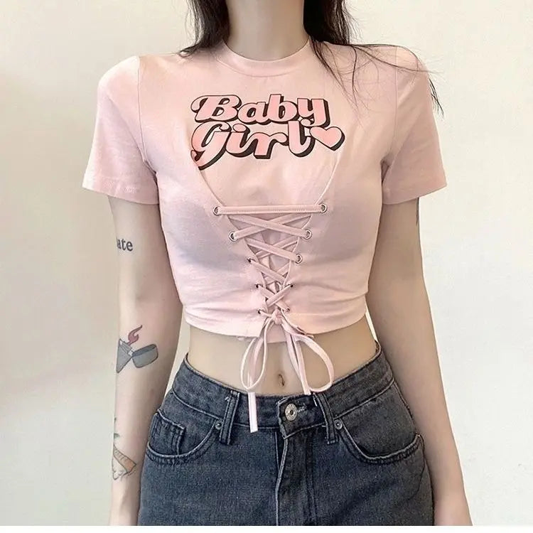 Babygirl Glow pink lace-up crop top combining baddiecore and soft girl fashion