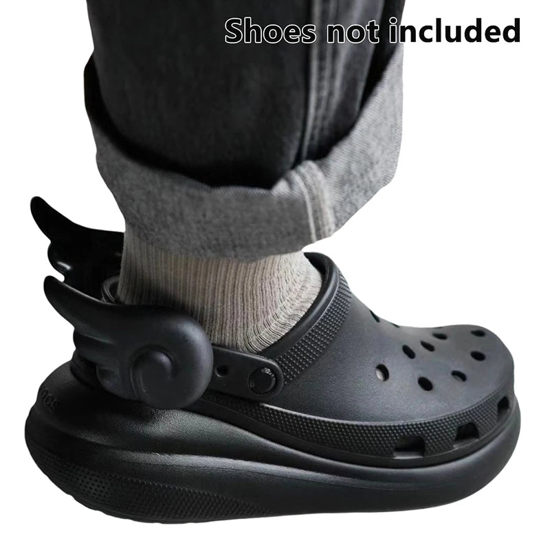 Black angel wing shoe charms displayed on black Crocs – gothic kawaii aesthetic