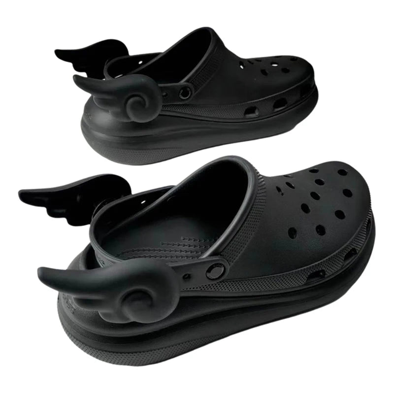 Black angel wing shoe charms styled on Crocs – pastel goth shoe fashion