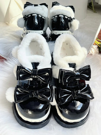 Black platform baby shoes with playful pom poms and ribbon bows, ideal for DDLG and cutecore aesthetics