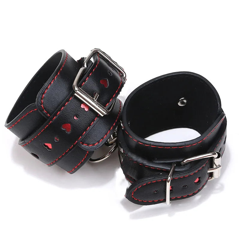 Black hand cuffs linked with red heart chain for DDLG play, cutecore aesthetic, and flirty fantasy outfits