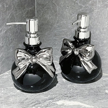 Black and silver princess bow refillable soap dispenser, kawaii cutecore bathroom accessory with chic vibes.