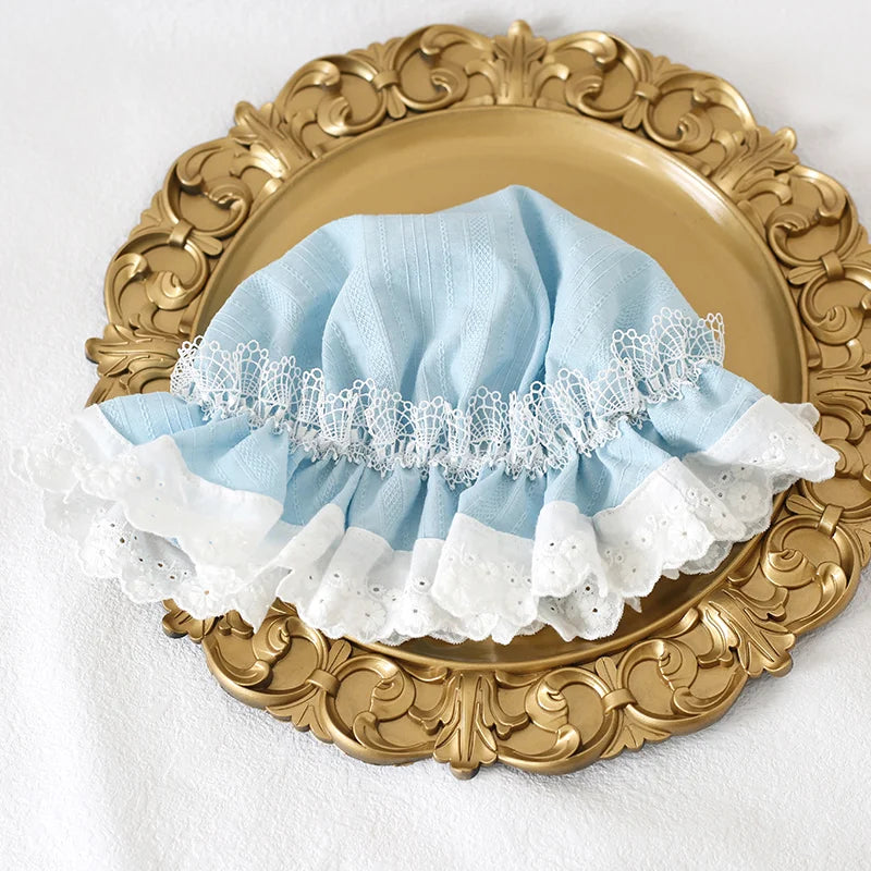 Lolita lace bonnet styled under blue sky with dreamy aesthetic