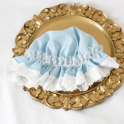 Lolita lace bonnet styled under blue sky with dreamy aesthetic