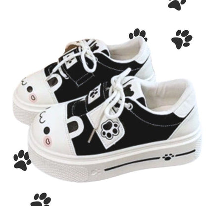 Black kawaii sneakers with blushing kitten face and paw prints, soft cutecore style for playful DDLG & ABDL vibes