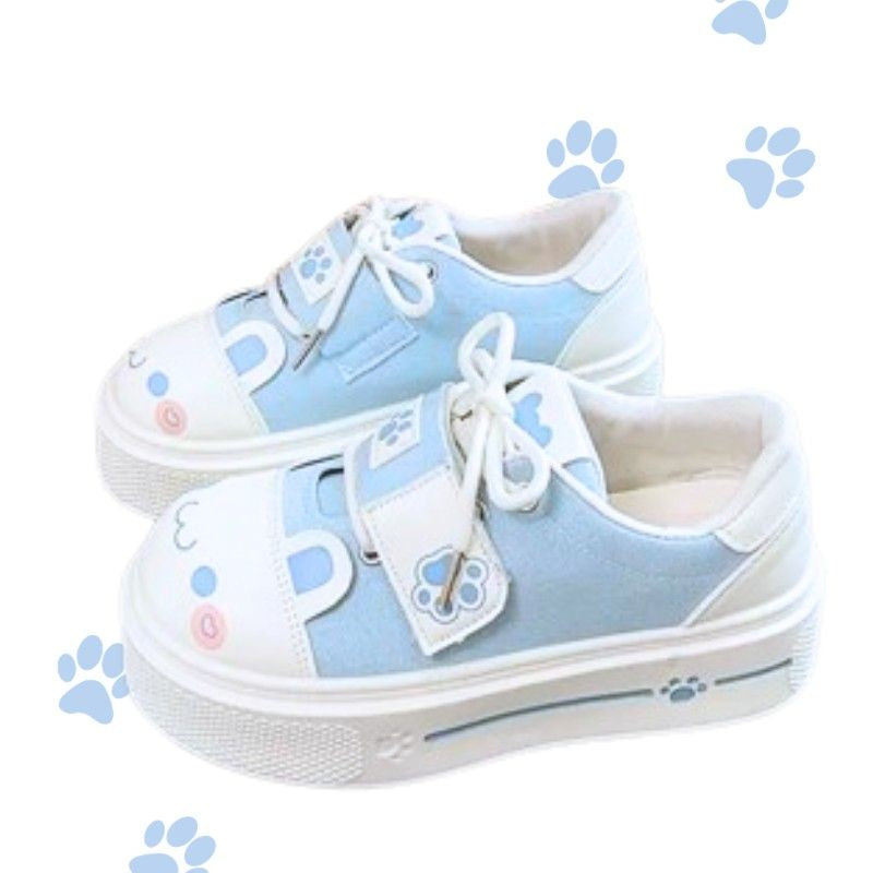 Cute pastel blue kawaii sneakers with blushing kitten face and playful paw accents for softcore vibes