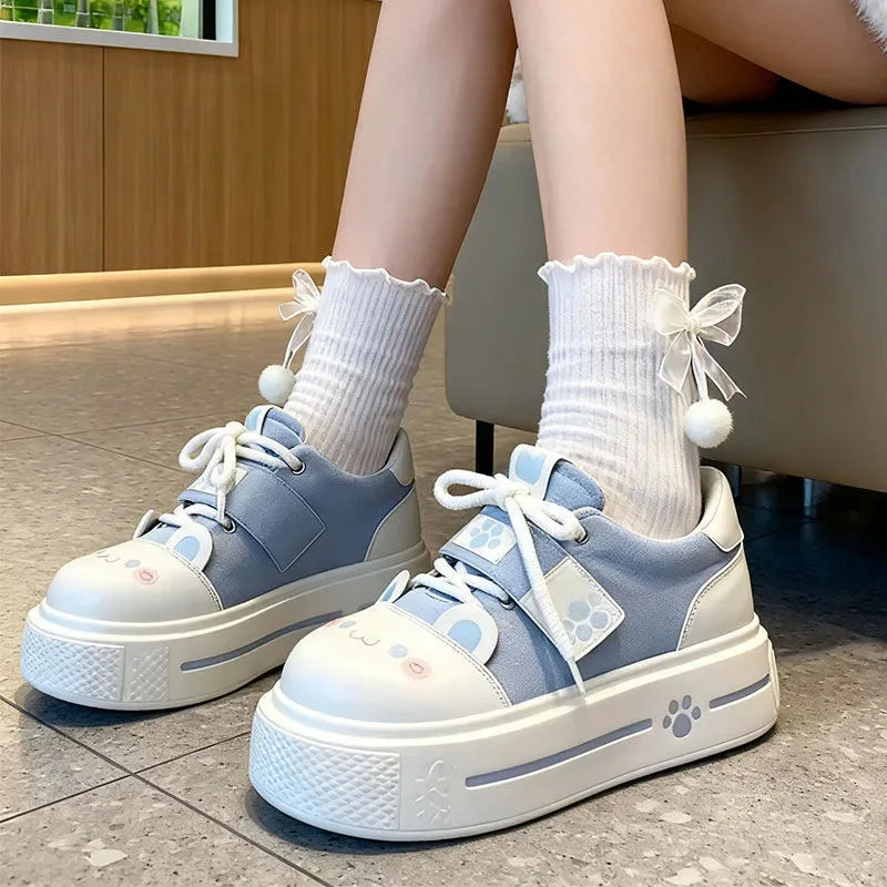 Blushing kitten paws sneakers in pastel blue with cute paw prints, kawaii DDLG/ABDL cutecore style
