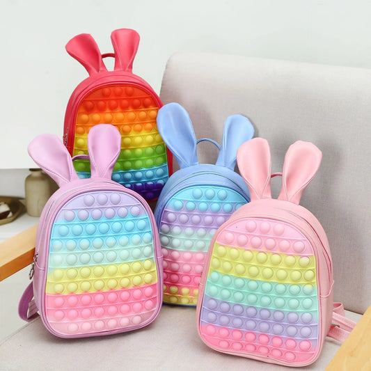 Bubble Pop Bunny Backpack set with red, purple, blue, and pink, kawaii DDLG silicone fidget bag