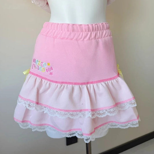 Bubblegum pink ruffle skirt with lace trim and side bows, perfect for kawaii and cute outfits